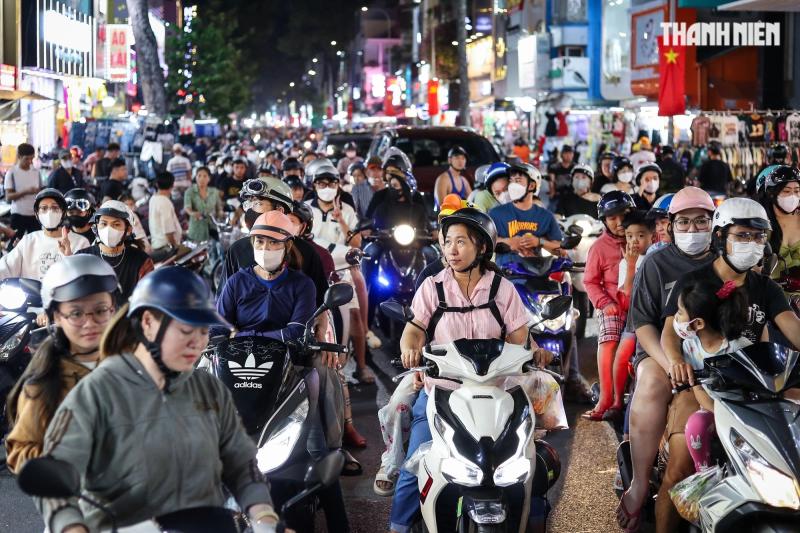 'Con đường quần áo' ở TP.HCM ào ạt xả hàng, cả trăm người mua sắm Tết đến tận khuya- Ảnh 1. 'Con đường quần áo' ở TP.HCM ào ạt xả hàng, cả trăm người mua sắm Tết đến tận khuya- Ảnh 1.